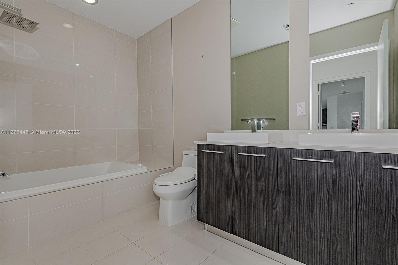 45 Southwest 9th Street, Unit 4206 Miami, FL 33130 - Photo 14 of 19 a bathroom with a sink a toilet and shower
