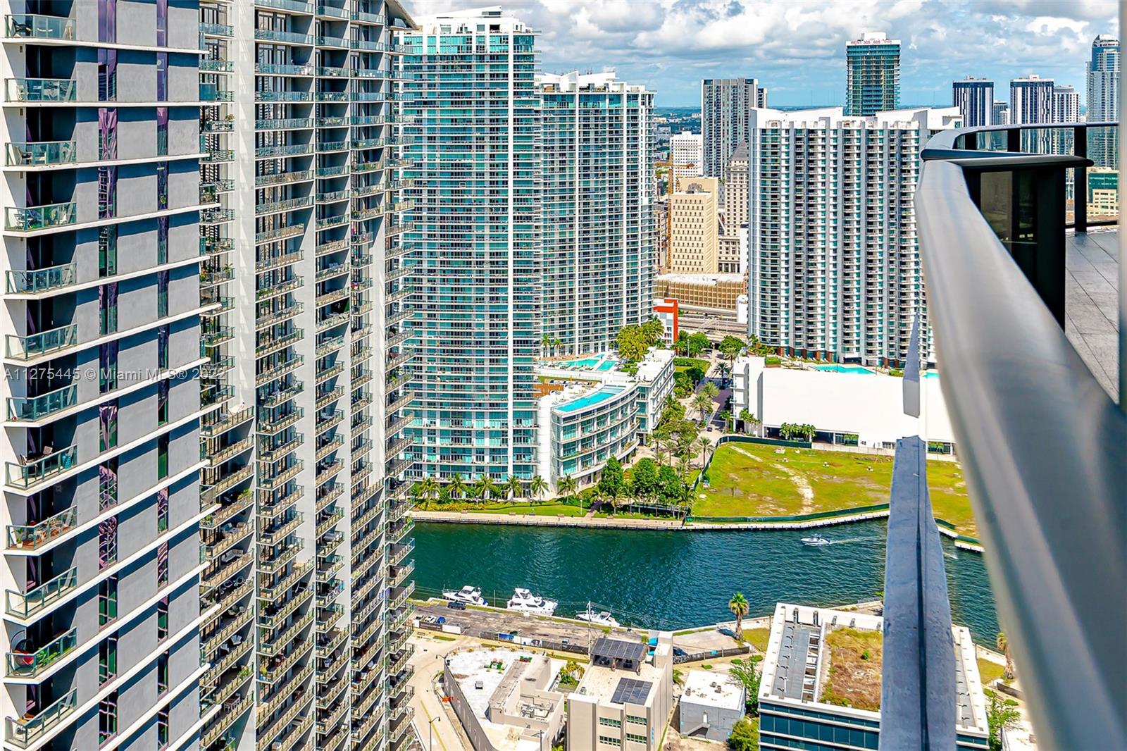 45 Southwest 9th Street, Unit 4206 Miami, FL 33130 - Photo 15 of 19 a view of balcony with two chairs and a potted plant