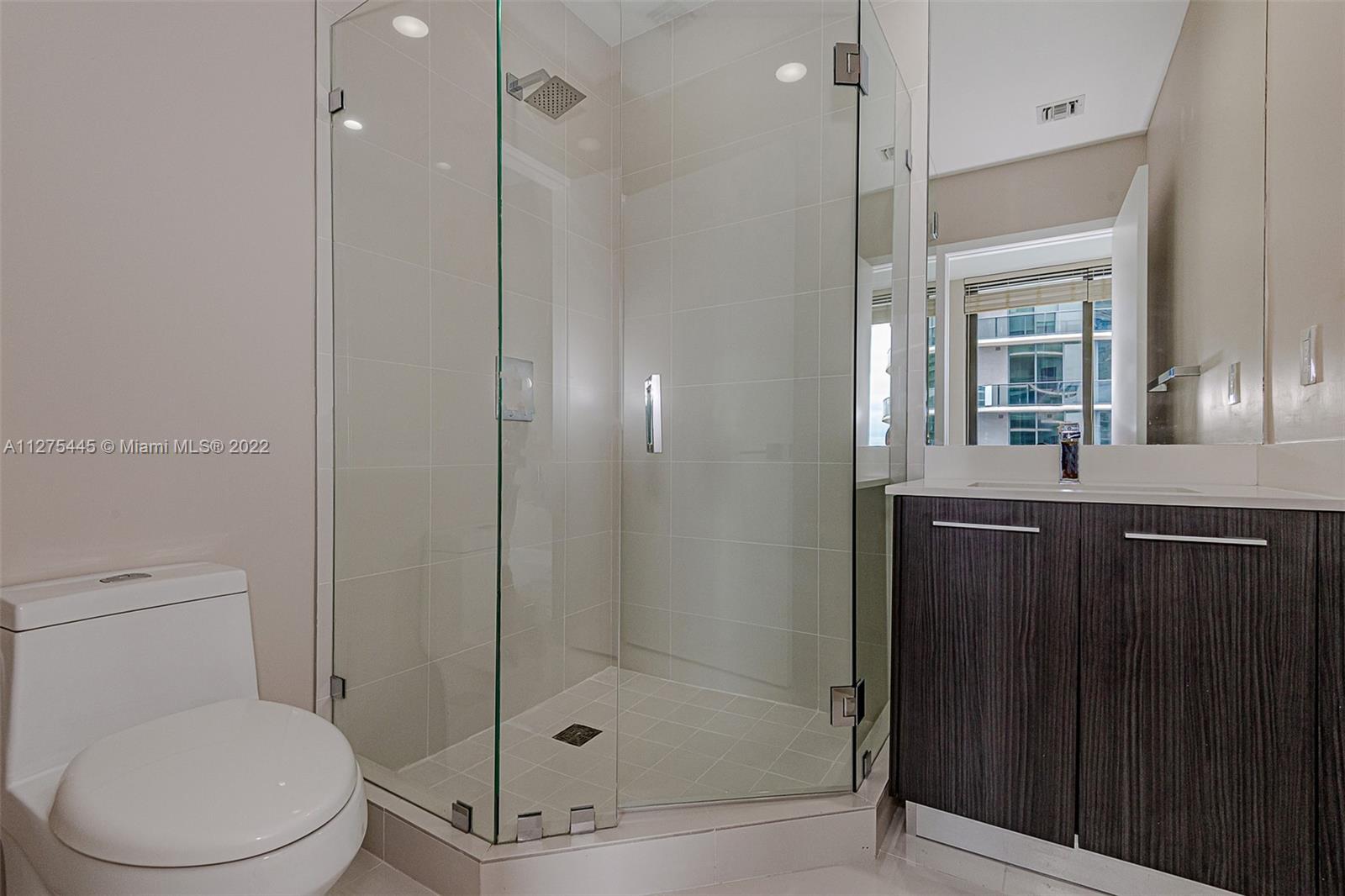 45 Southwest 9th Street, Unit 4206 Miami, FL 33130 - Photo 16 of 19 a bathroom with a toilet a sink and shower