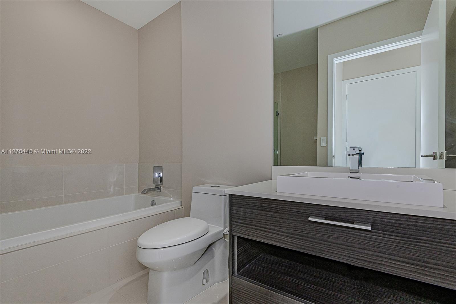 45 Southwest 9th Street, Unit 4206 Miami, FL 33130 - Photo 18 of 19 a bathroom with a sink a toilet and shower
