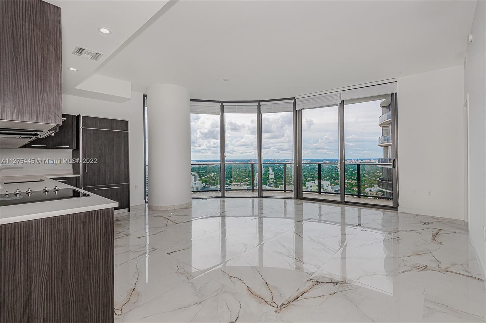 45 Southwest 9th Street, Unit 4206 Miami, FL 33130 - Photo 2 of 19 a view of a kitchen with a sink and a refrigerator