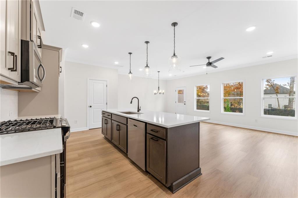 340 Colsen Drive Acworth, GA 30102 - Photo 4 of 25 a kitchen with stainless steel appliances granite countertop a sink a stove and a wooden floors