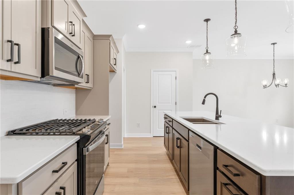 340 Colsen Drive Acworth, GA 30102 - Photo 10 of 25 a kitchen with stainless steel appliances a sink and a stove