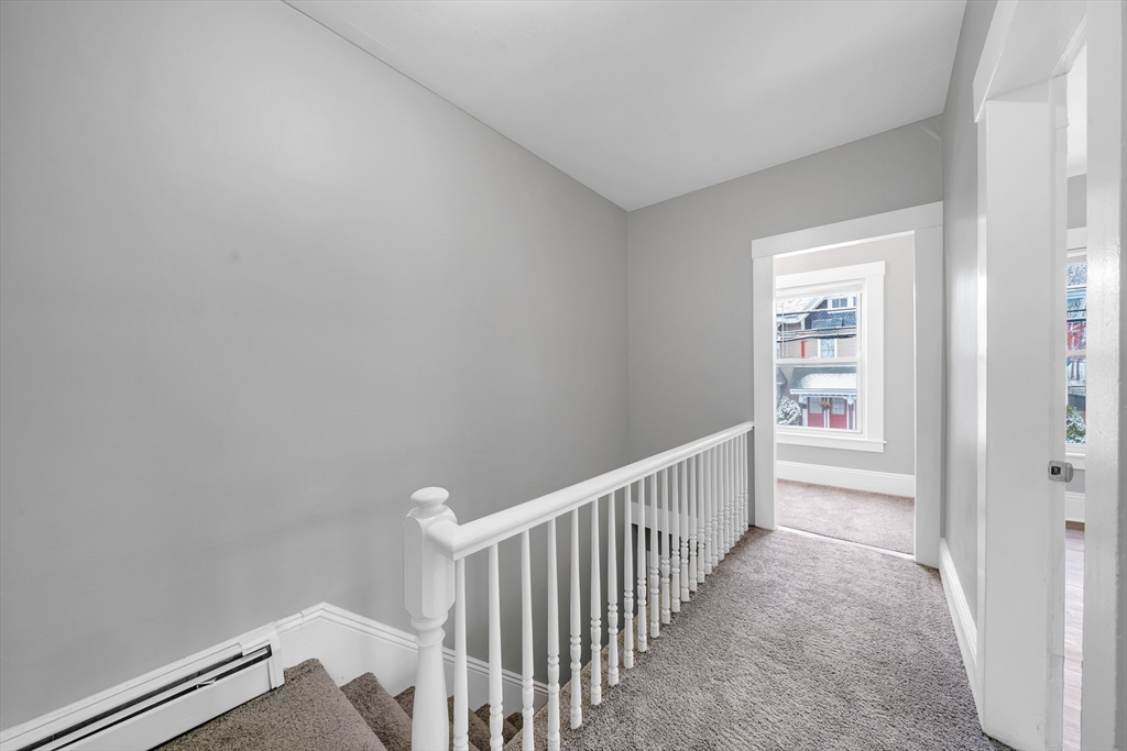 49 6th Street Lowell, MA 01850 - Photo 18 of 37 a view of a hallway with a white walls