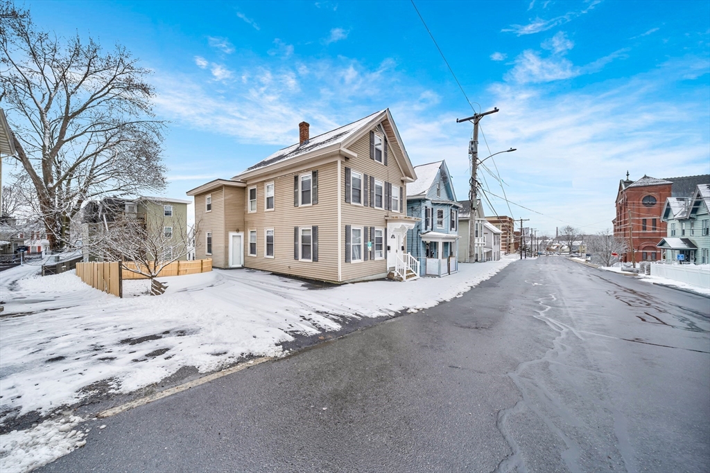 49 6th Street Lowell, MA 01850 - Photo 2 of 37 a view of a house with snow on the road