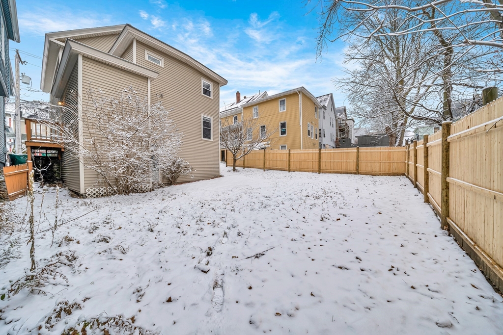 49 6th Street Lowell, MA 01850 - Photo 3 of 37 a front view of a house with a yard