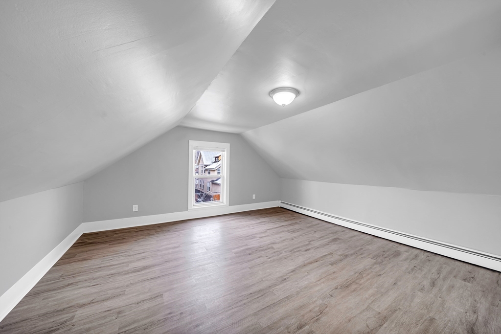 49 6th Street Lowell, MA 01850 - Photo 32 of 37 wooden floor in an empty room with a window