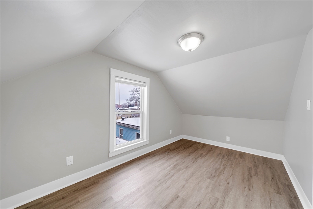 49 6th Street Lowell, MA 01850 - Photo 35 of 37 wooden floor in an empty room with a window