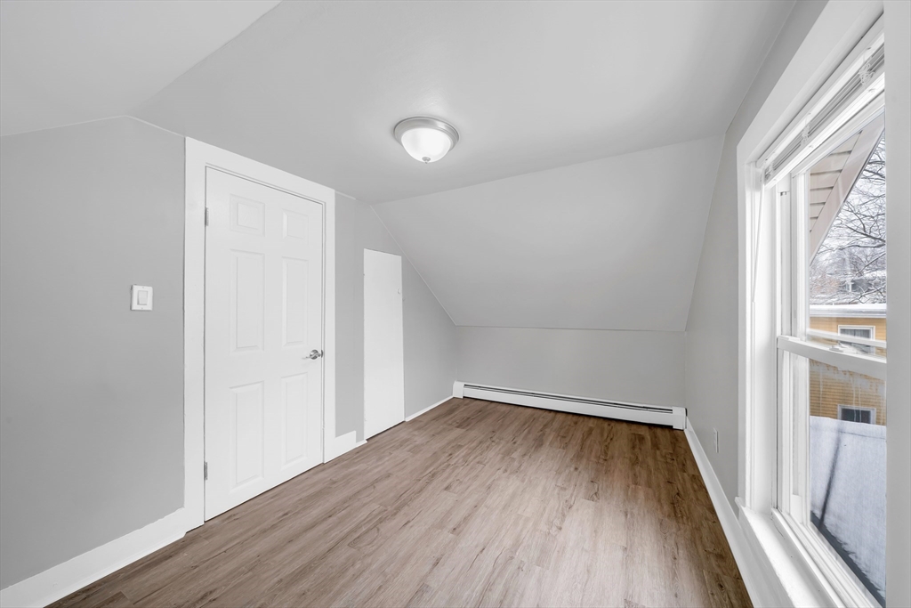 49 6th Street Lowell, MA 01850 - Photo 36 of 37 wooden floor in an empty room with a window