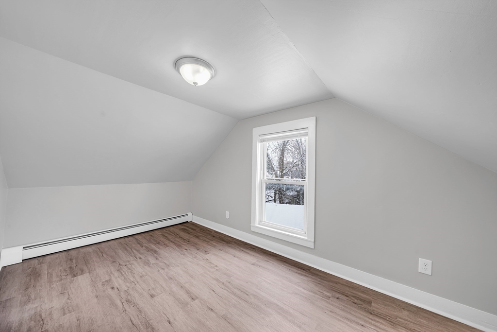 49 6th Street Lowell, MA 01850 - Photo 37 of 37 an empty room with wooden floor and windows