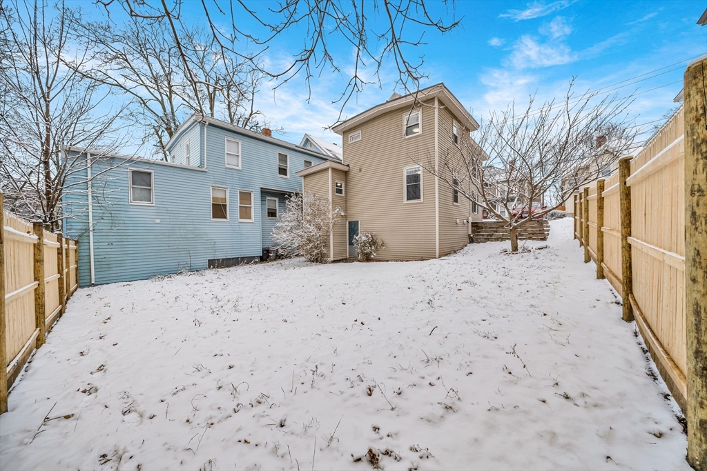 49 6th Street Lowell, MA 01850 - Photo 4 of 37 a view of a house with a snow in the yard