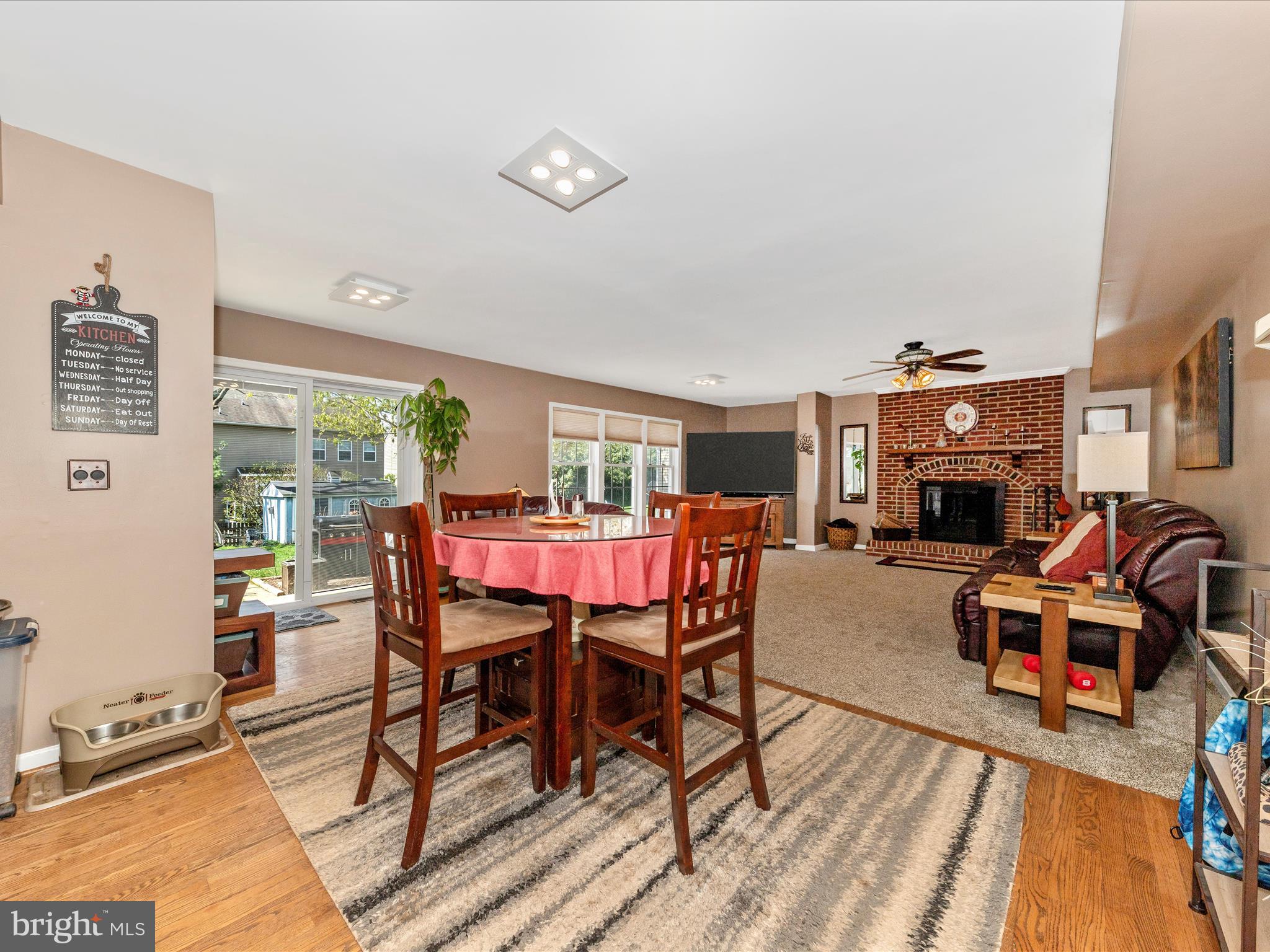 2406 Graystone Lane Frederick, MD 21702 - Photo 13 of 62 a dining room with furniture wooden floor and a rug