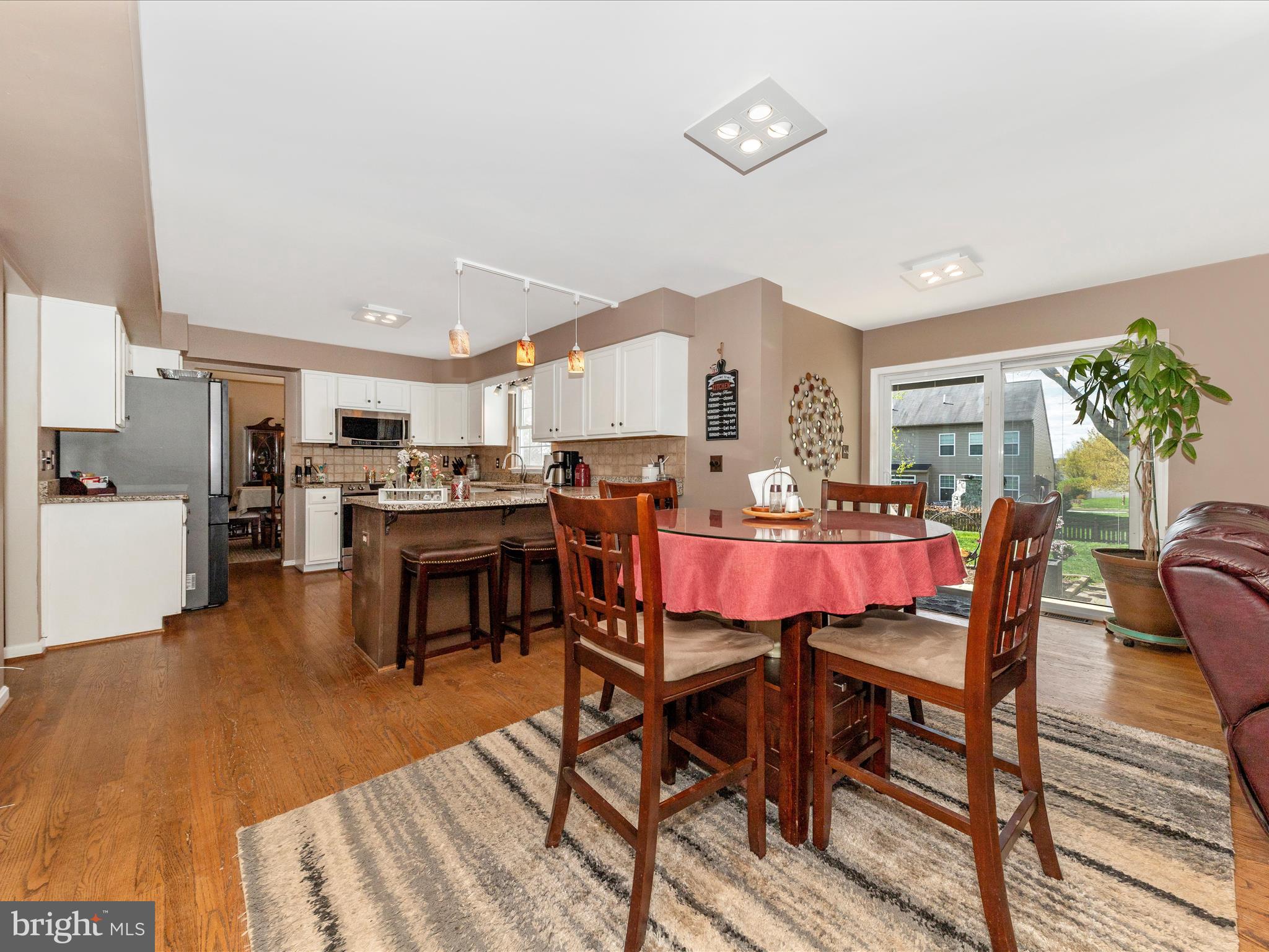 2406 Graystone Lane Frederick, MD 21702 - Photo 14 of 62 a view of a dining room with furniture and wooden floor