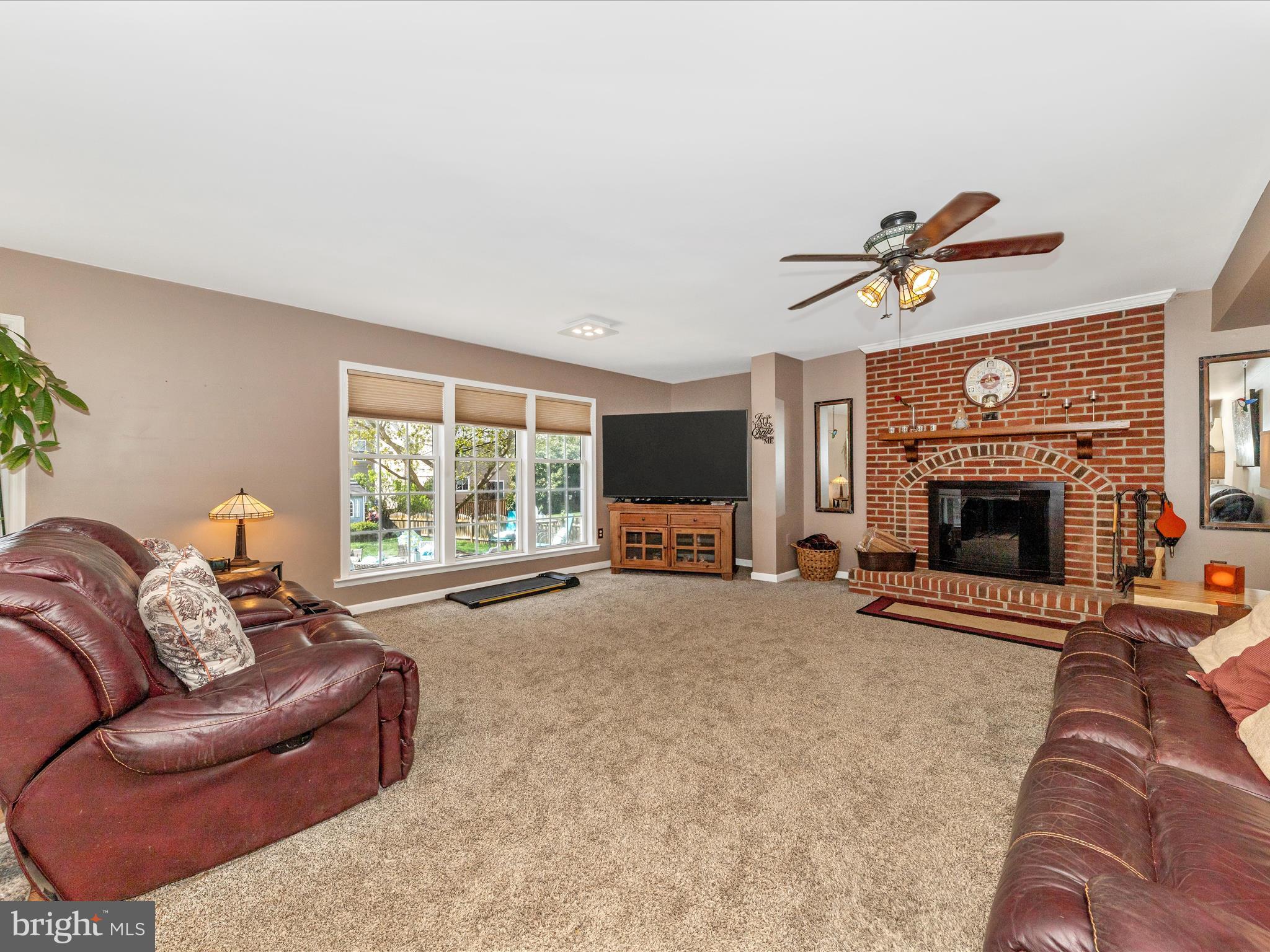 2406 Graystone Lane Frederick, MD 21702 - Photo 15 of 62 a living room with furniture a window and a fireplace