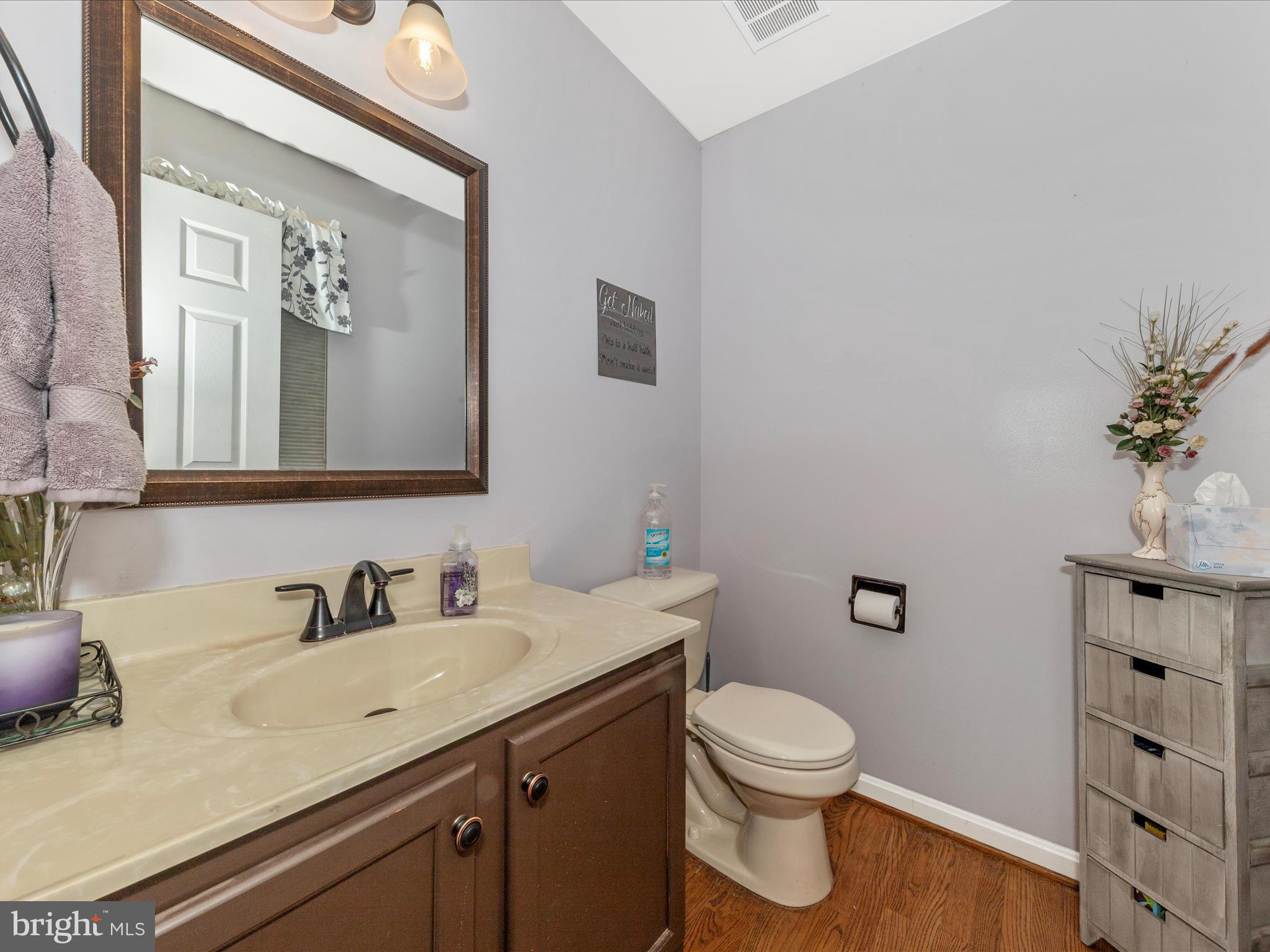 2406 Graystone Lane Frederick, MD 21702 - Photo 19 of 62 a bathroom with a granite countertop sink a toilet and a mirror
