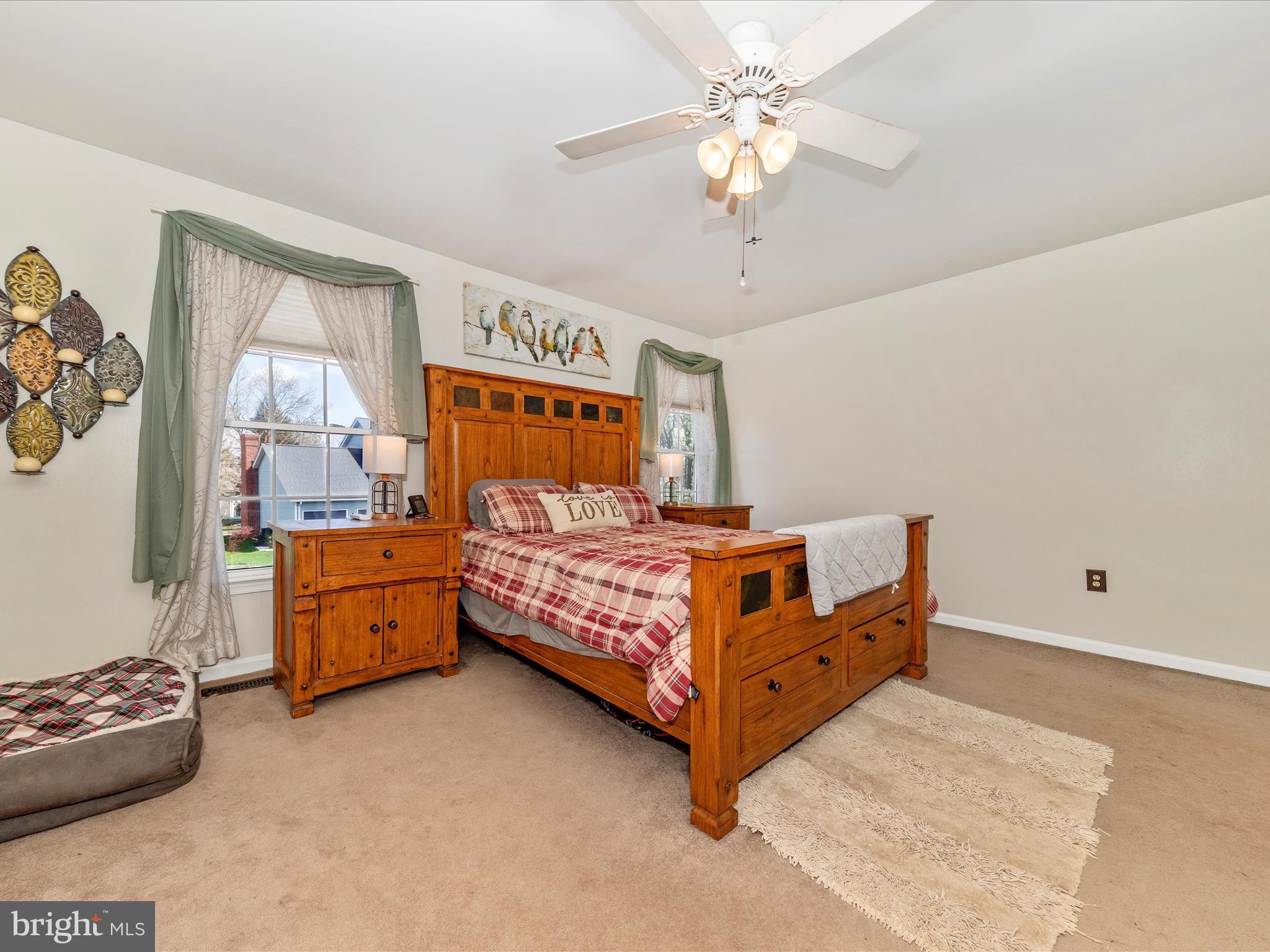 2406 Graystone Lane Frederick, MD 21702 - Photo 23 of 62 a bedroom with a bed and a chandelier