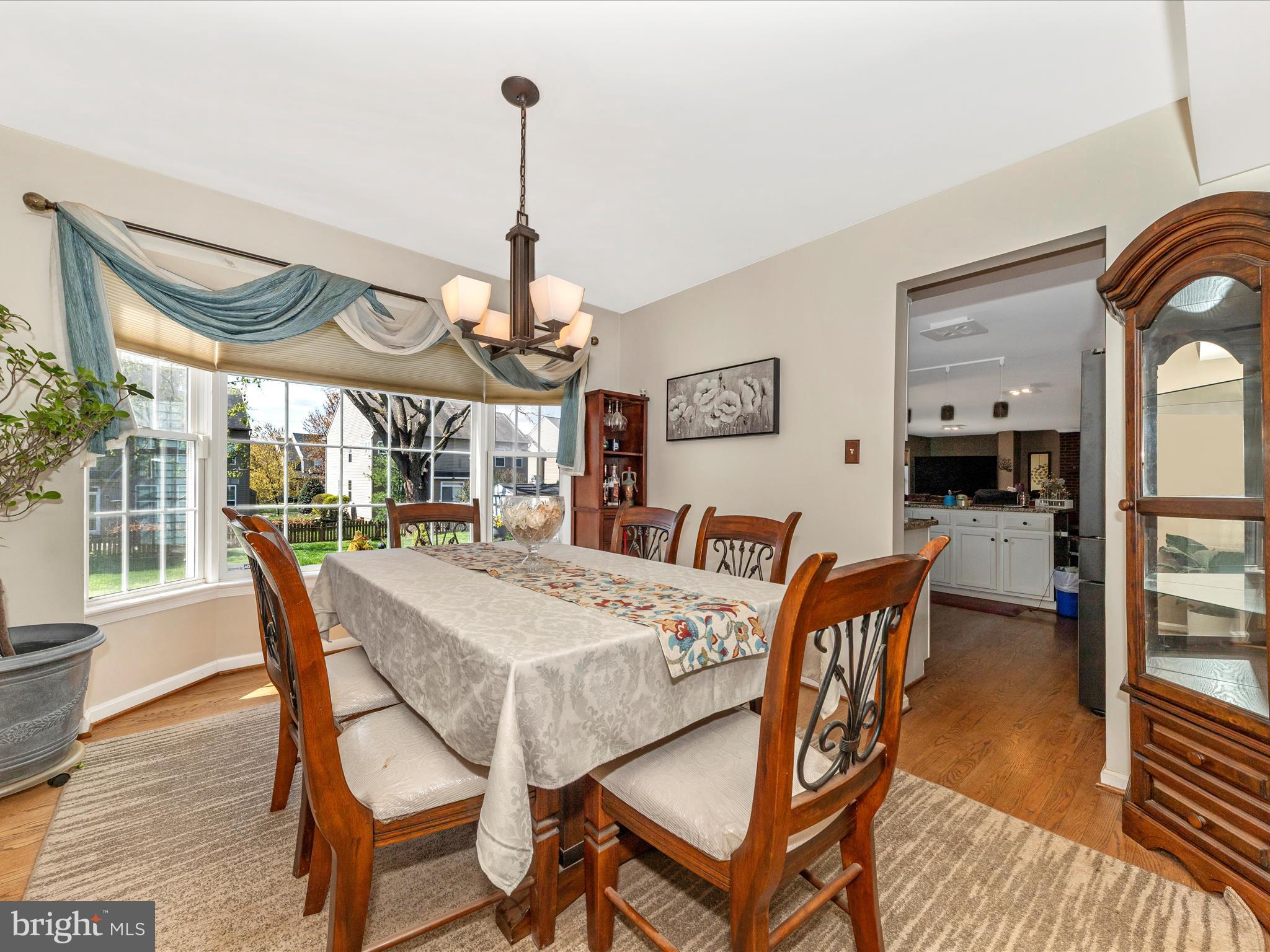 2406 Graystone Lane Frederick, MD 21702 - Photo 8 of 62 a view of a dining room with furniture window and wooden floor