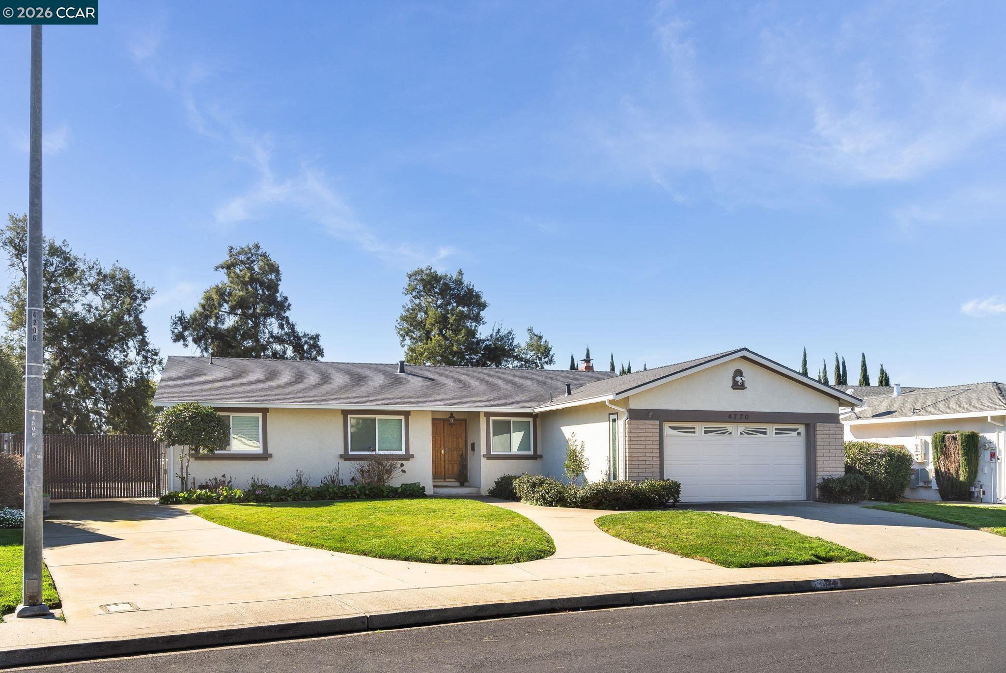 4770 Olive Drive Concord, CA 94521 - Photo 1 of 1 a front view of a house with a yard and garage