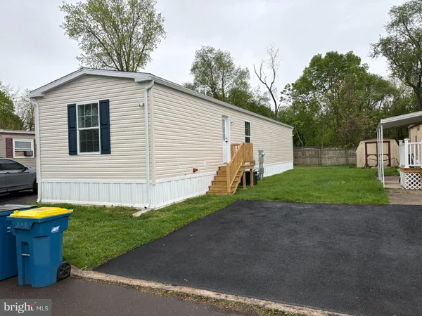 a view of a house with backyard and chairs
