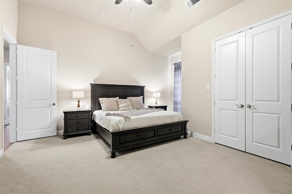 7751 Faught Road Northlake, TX 76226 - Photo 24 of 39 Spacious bedroom featuring vaulted ceilings, light neutral wall paint, and light-toned carpeting