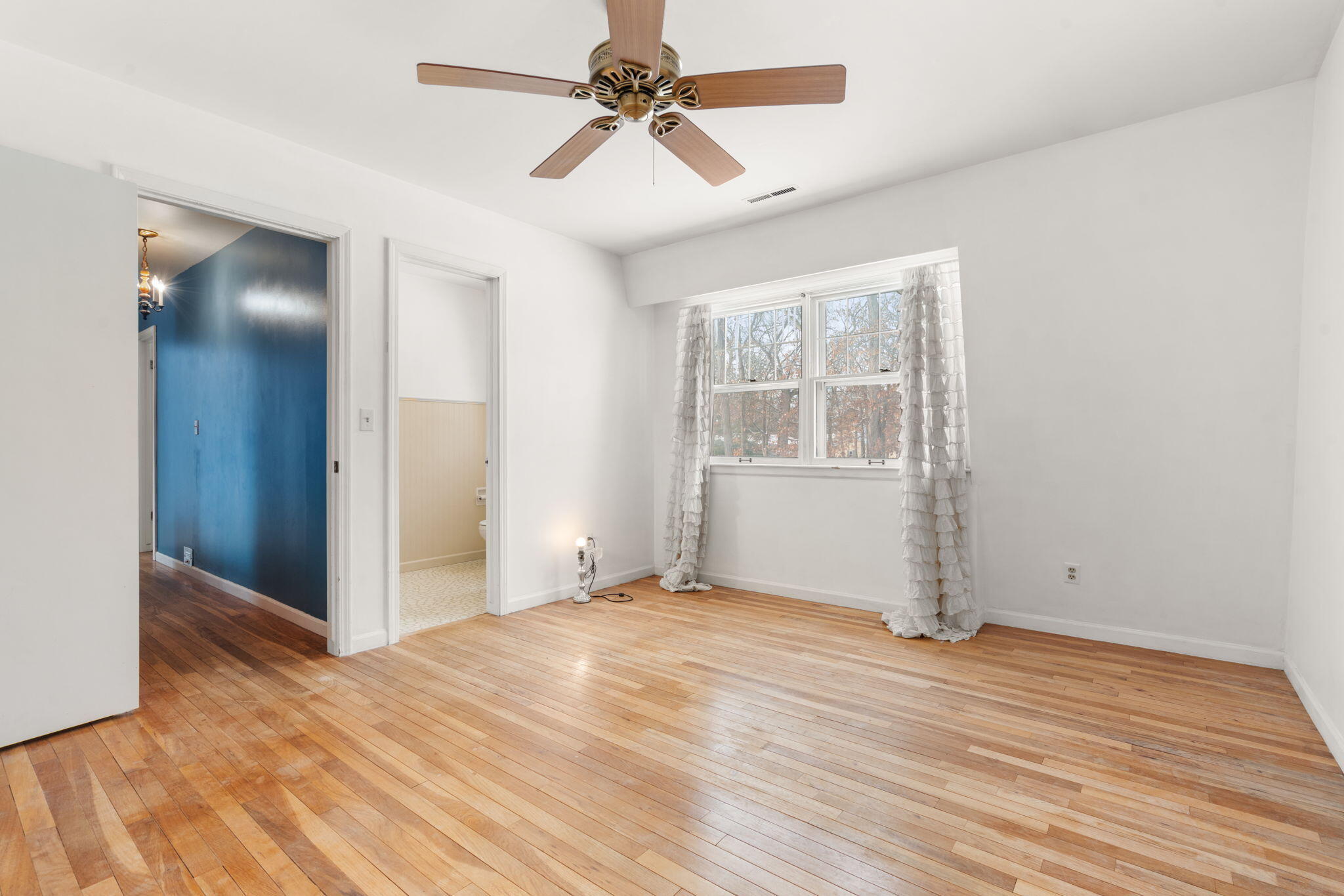 12322 Alexander Street Cedar Lake, IN 46303 - Photo 14 of 21 an empty room with wooden floor chandelier fan and windows