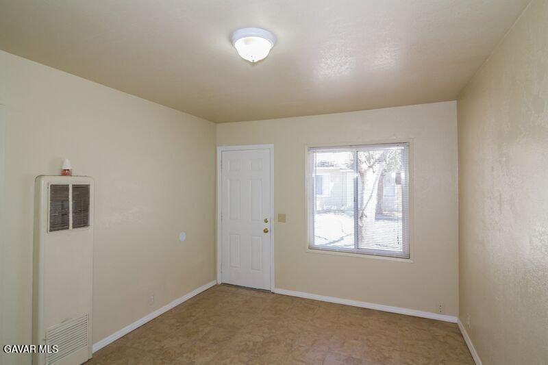 2618 Desert Street, Unit 11 Rosamond, CA 93560 - Photo 4 of 8 an empty room with windows