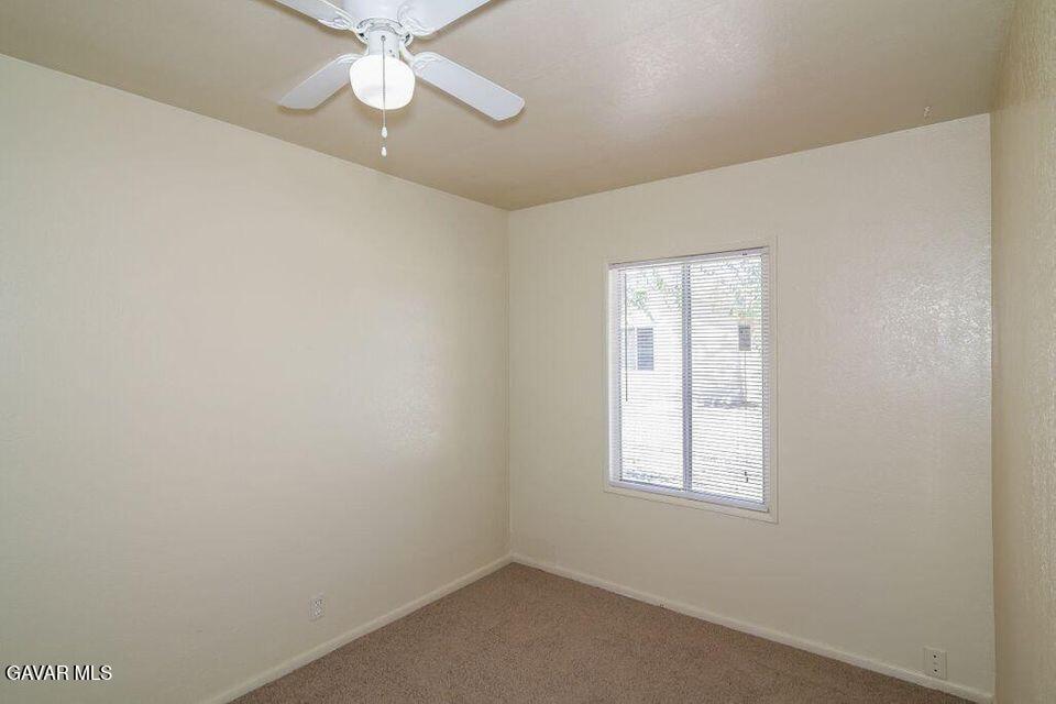 2618 Desert Street, Unit 11 Rosamond, CA 93560 - Photo 7 of 8 an empty room with a window and a fan