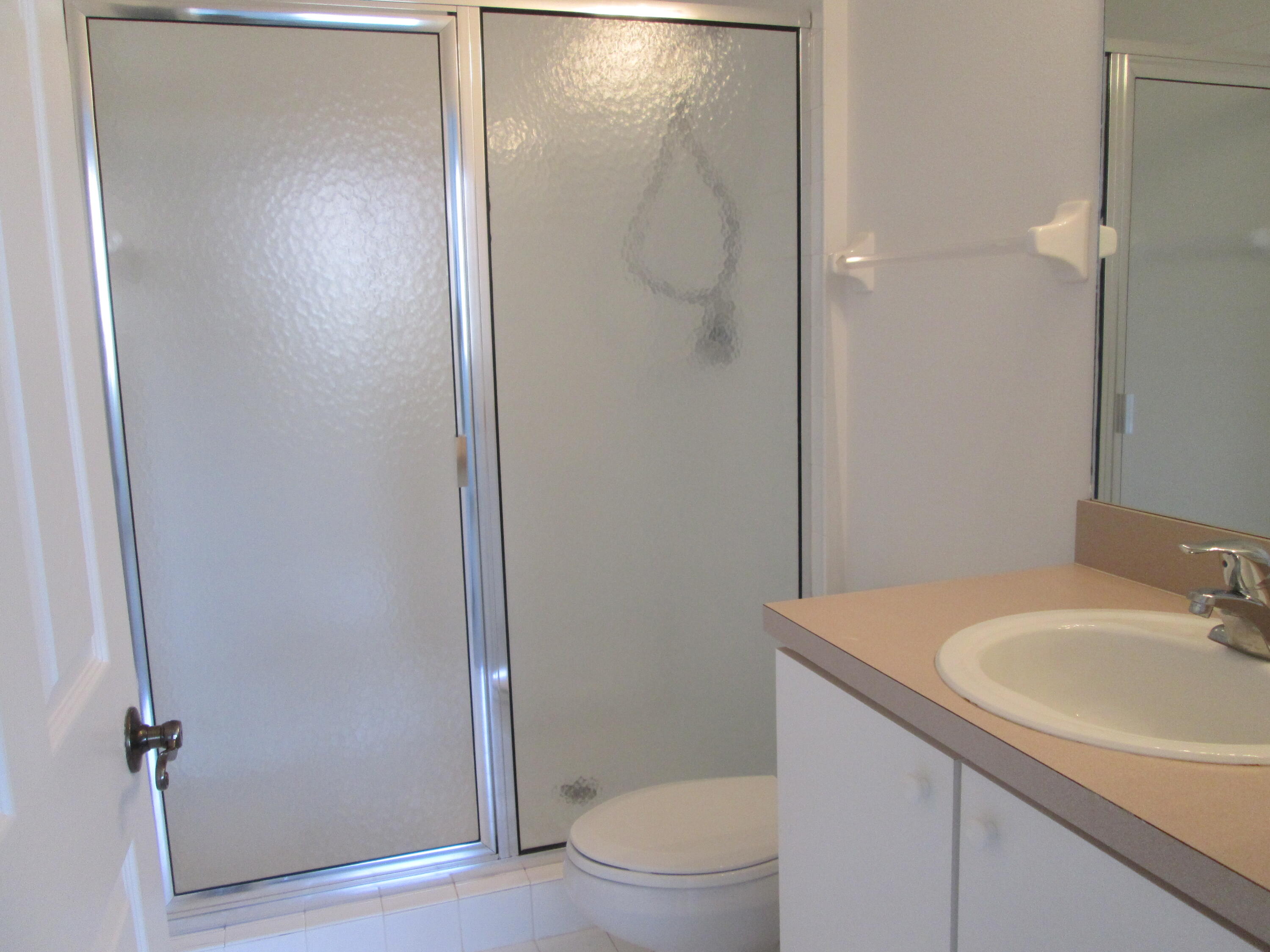 105 Lighthouse Circle, Unit J Tequesta, FL 33469 - Photo 12 of 18 a bathroom with a sink and mirror