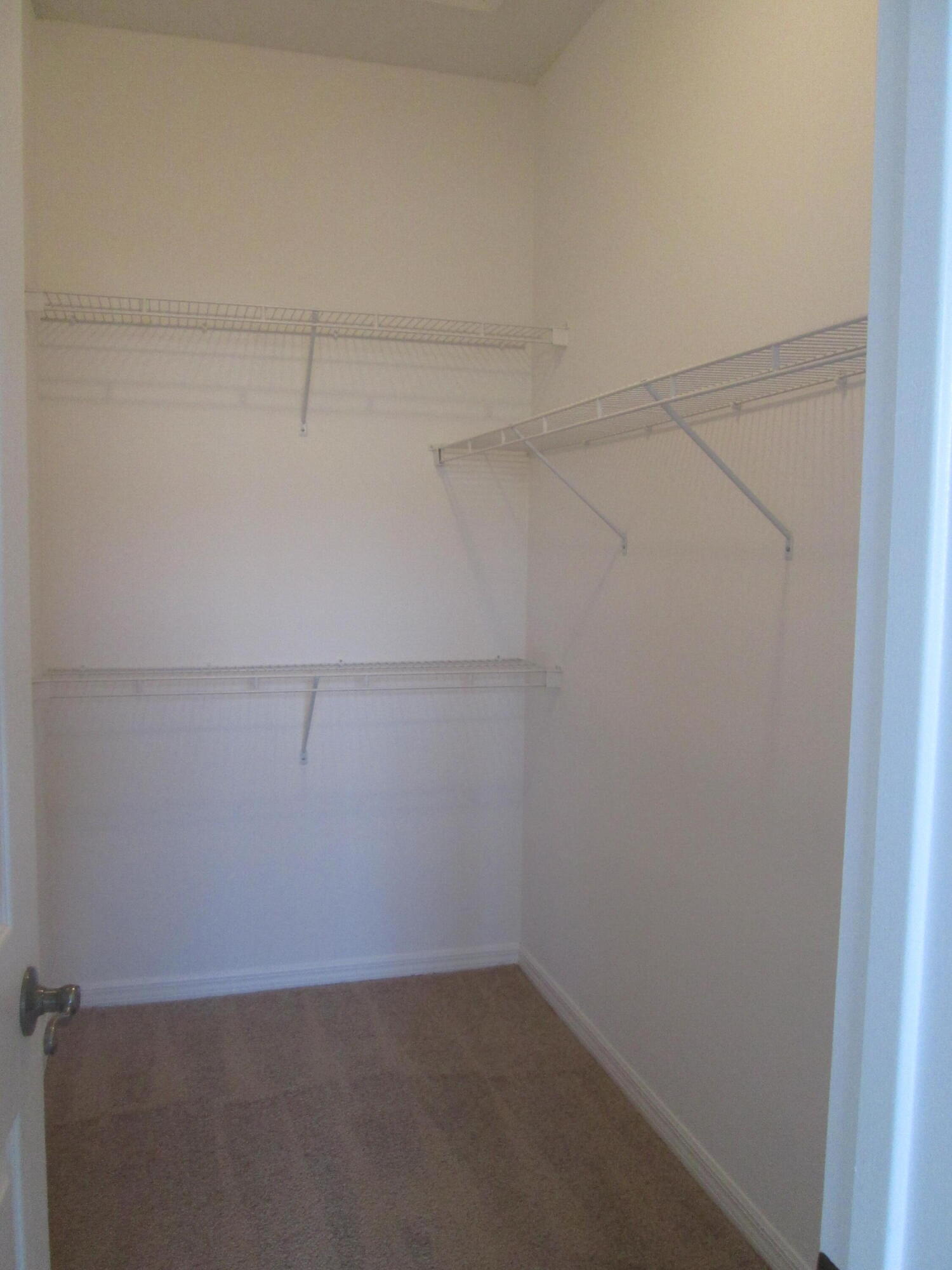 105 Lighthouse Circle, Unit J Tequesta, FL 33469 - Photo 13 of 18 a view of a room with racks on the wall