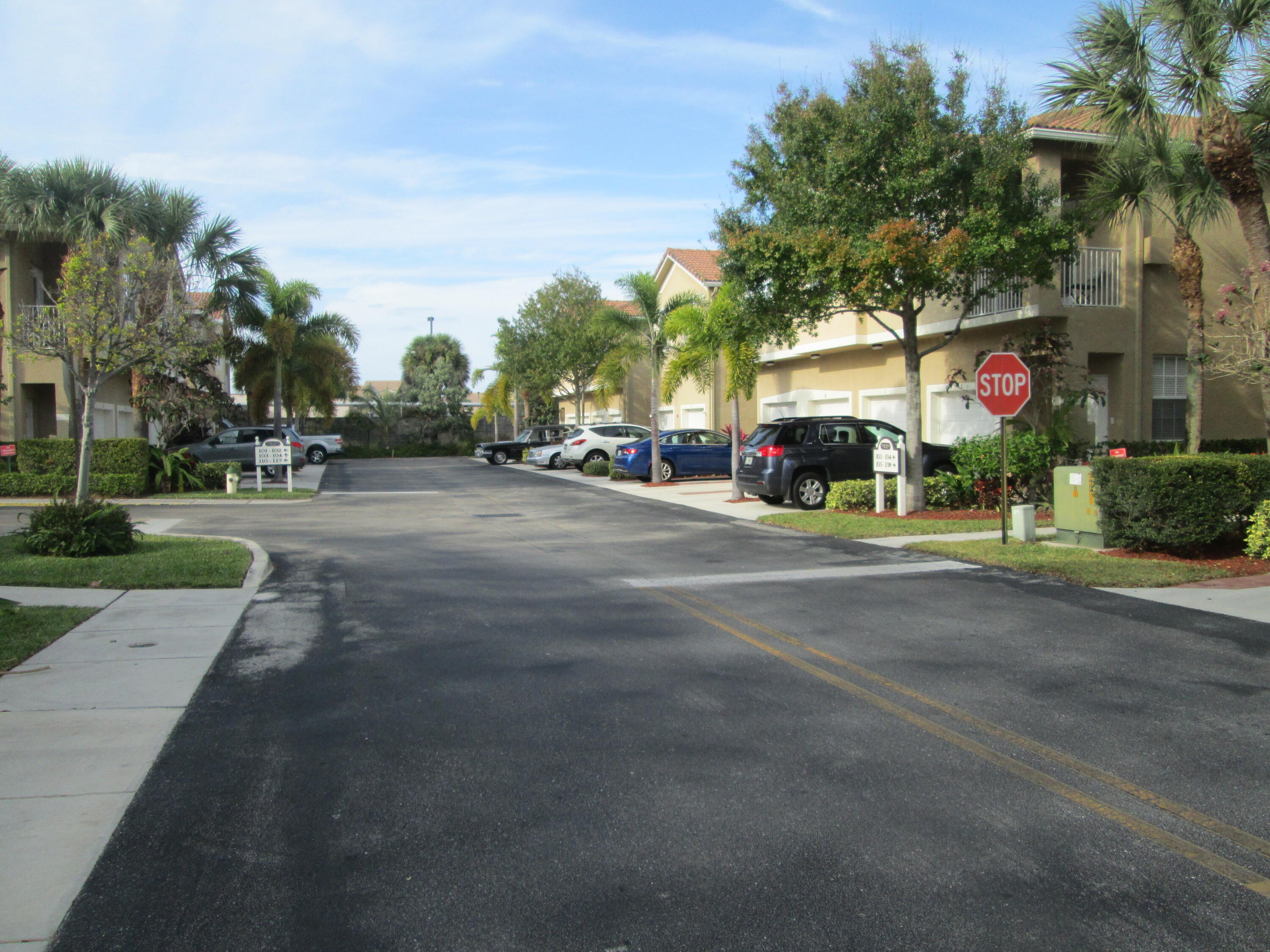 105 Lighthouse Circle, Unit J Tequesta, FL 33469 - Photo 17 of 18 a view of street with parked cars