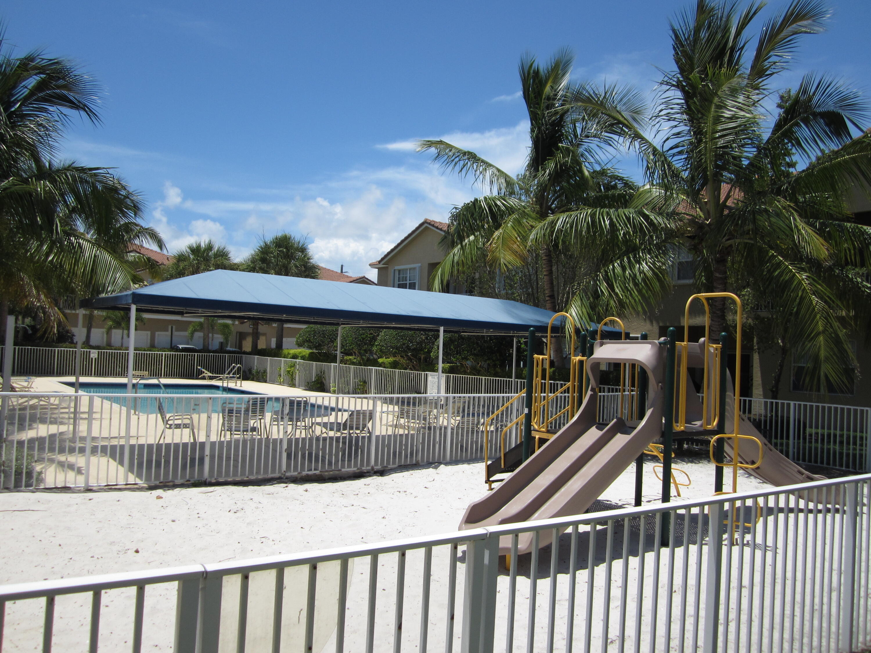 105 Lighthouse Circle, Unit J Tequesta, FL 33469 - Photo 2 of 18 a view of a house with a swimming pool