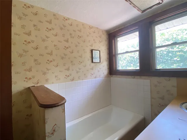 a bathroom with a bathtub and window