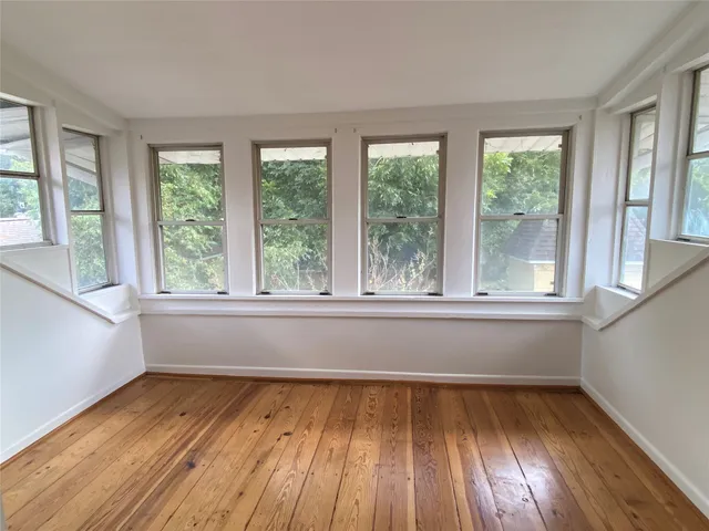 a view of room with window and wooden floor