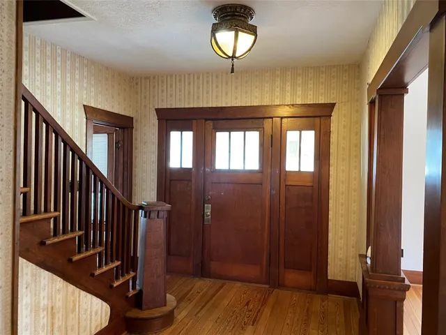 a view of a hallway with wooden floor and entryway
