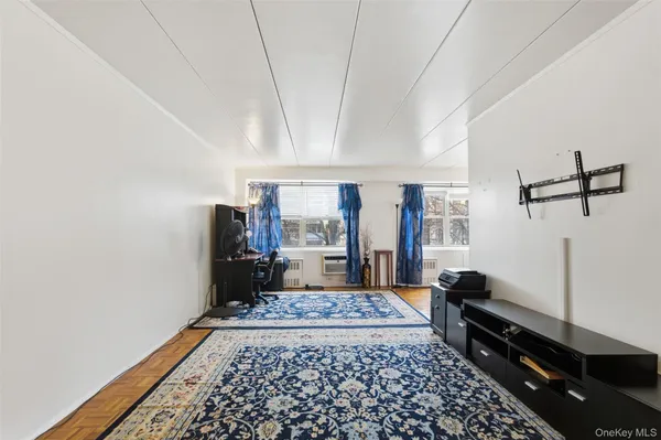 a bed room with a bed furniture and a flat tv screen