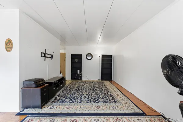 a living room with furniture a rug and a flat screen tv