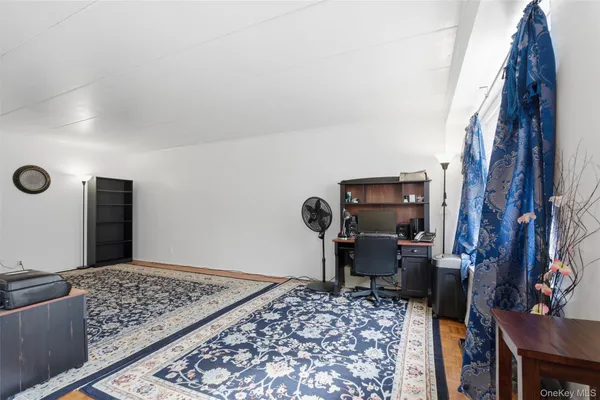 a view of a living room with stainless steel appliances granite countertop furniture and a fireplace