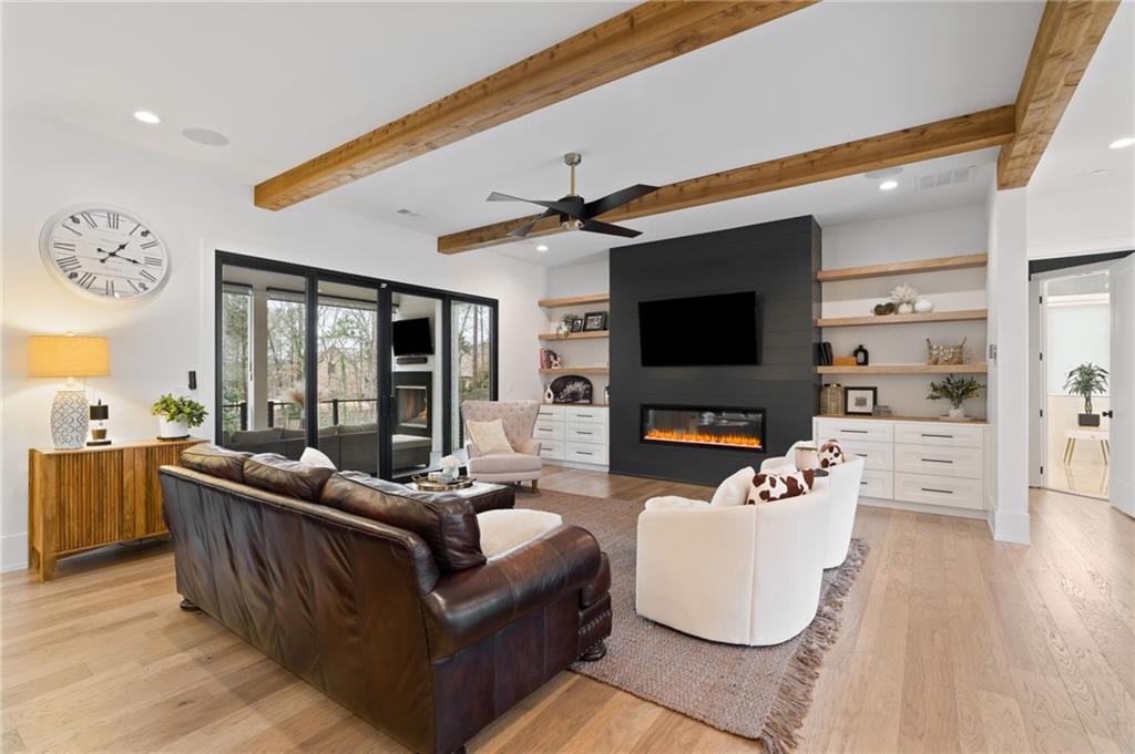 4226 South Berkeley Lake Road Northwest Berkeley Lake, GA 30096 - Photo 14 of 61 a living room with furniture flat screen tv and a fireplace