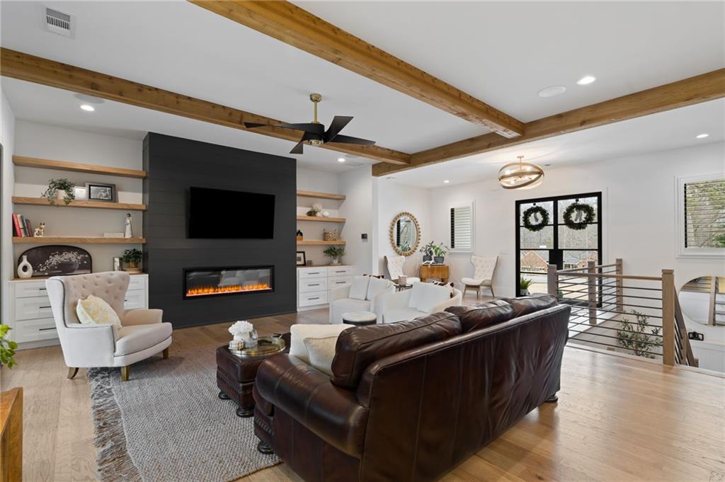4226 South Berkeley Lake Road Northwest Berkeley Lake, GA 30096 - Photo 16 of 61 a living room with furniture and a flat screen tv