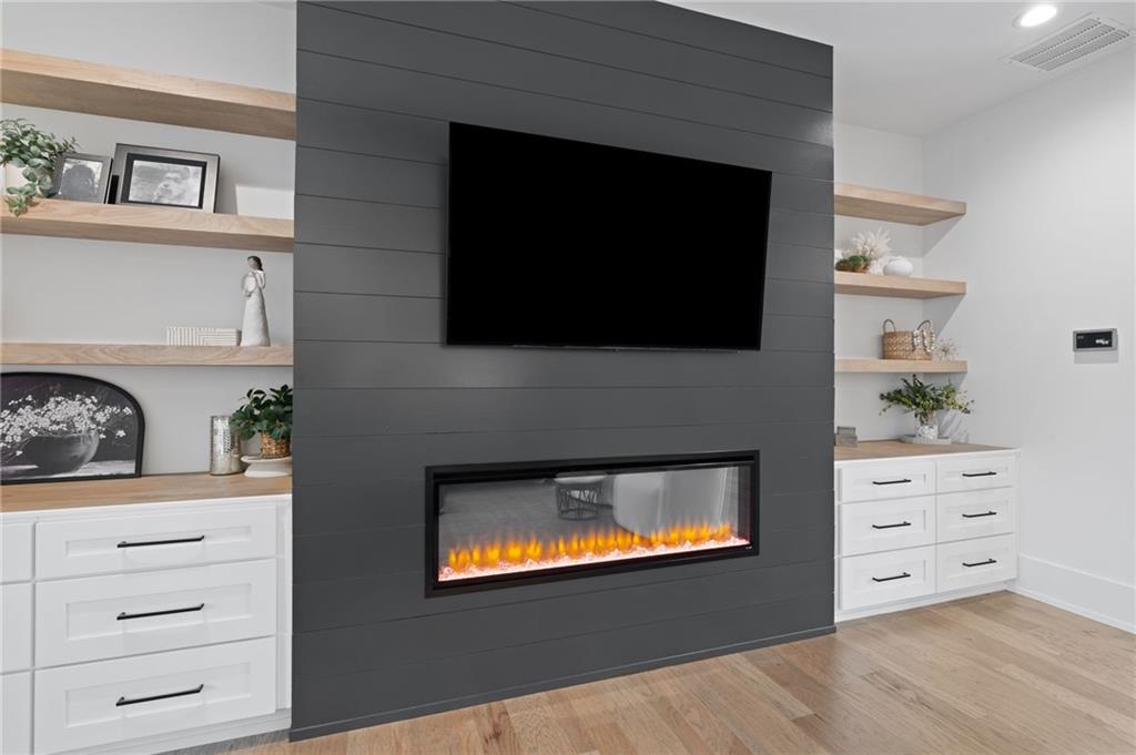 4226 South Berkeley Lake Road Northwest Berkeley Lake, GA 30096 - Photo 17 of 61 a view of room with cabinet and a flat screen tv
