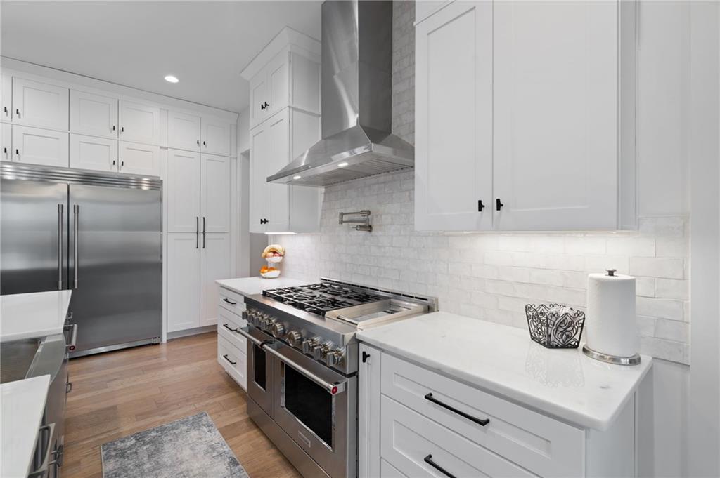 4226 South Berkeley Lake Road Northwest Berkeley Lake, GA 30096 - Photo 19 of 61 a kitchen with granite countertop a sink stainless steel appliances and cabinets