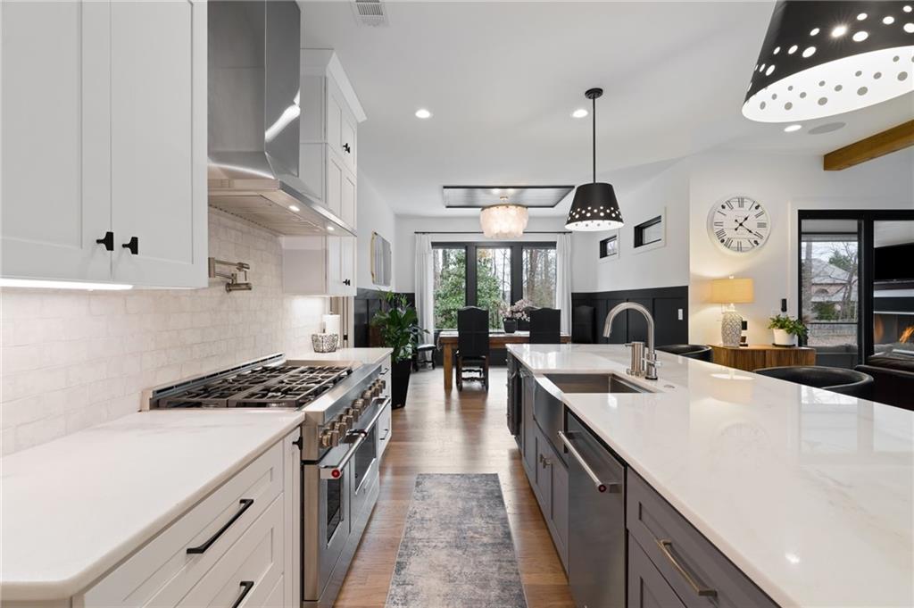4226 South Berkeley Lake Road Northwest Berkeley Lake, GA 30096 - Photo 20 of 61 a kitchen with stainless steel appliances granite countertop a sink stove and refrigerator
