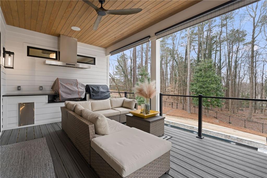 4226 South Berkeley Lake Road Northwest Berkeley Lake, GA 30096 - Photo 21 of 61 a living room with furniture and a floor to ceiling window