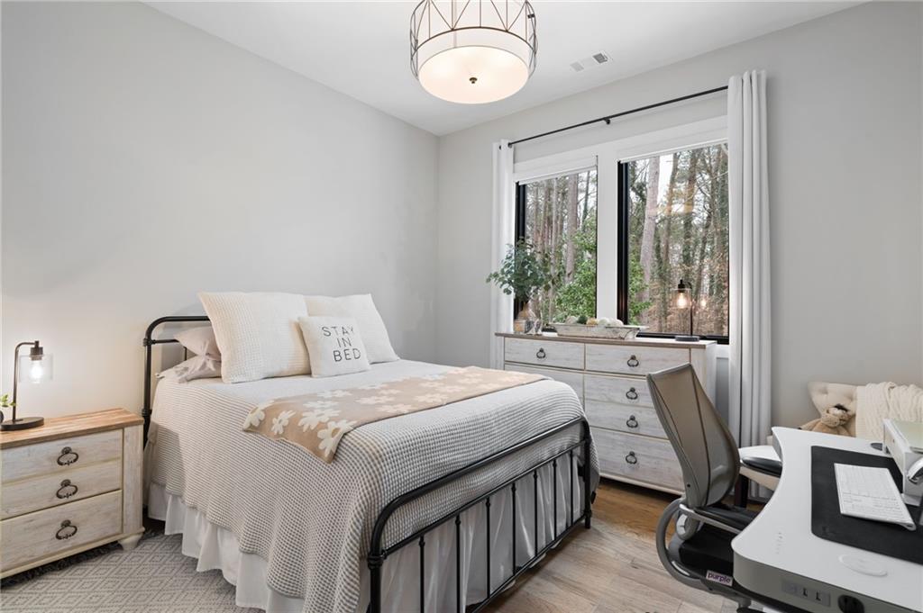 4226 South Berkeley Lake Road Northwest Berkeley Lake, GA 30096 - Photo 23 of 61 a bedroom with a bed and a table