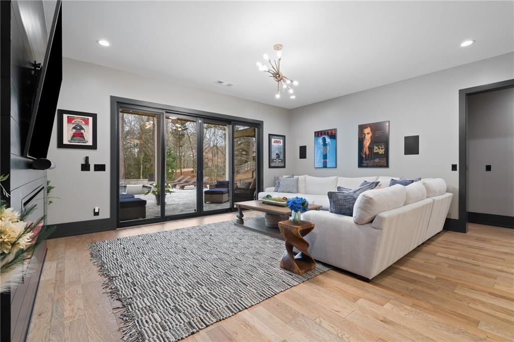 4226 South Berkeley Lake Road Northwest Berkeley Lake, GA 30096 - Photo 25 of 61 a living room with furniture and a flat screen tv