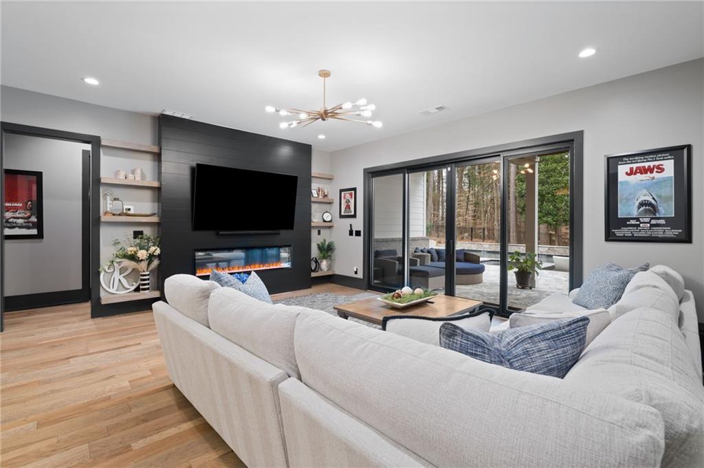 4226 South Berkeley Lake Road Northwest Berkeley Lake, GA 30096 - Photo 26 of 61 a living room with furniture and a flat screen tv