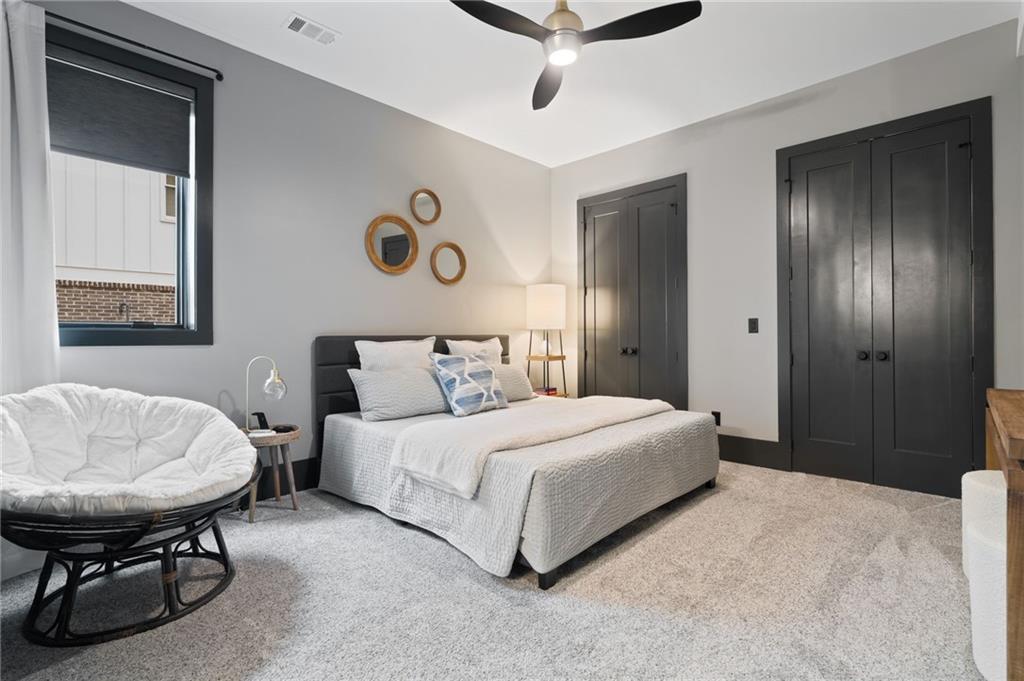 4226 South Berkeley Lake Road Northwest Berkeley Lake, GA 30096 - Photo 29 of 61 a bedroom with a bed and a table in it