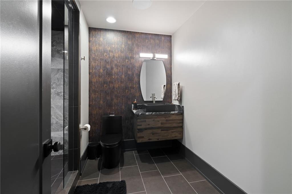 4226 South Berkeley Lake Road Northwest Berkeley Lake, GA 30096 - Photo 35 of 61 a bathroom with a mirror and a shower
