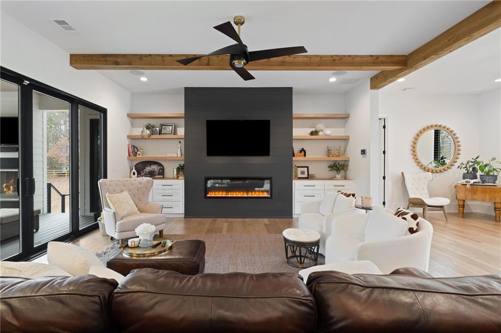 4226 South Berkeley Lake Road Northwest Berkeley Lake, GA 30096 - Photo 5 of 61 a living room with furniture and a flat screen tv