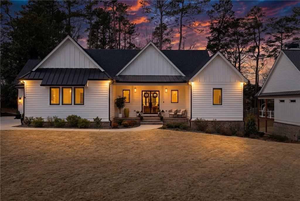 4226 South Berkeley Lake Road Northwest Berkeley Lake, GA 30096 - Photo 60 of 61 a front view of a house with a yard and garage